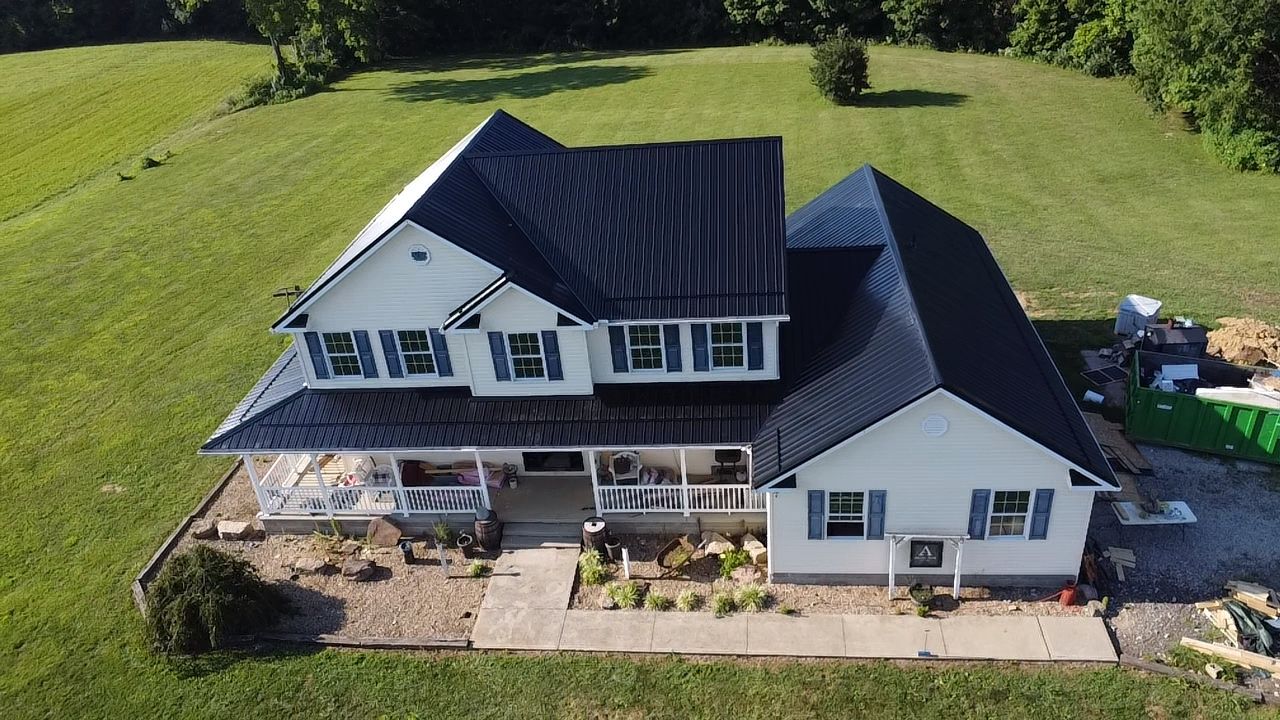 Farmhouse with black standing seam metal roof