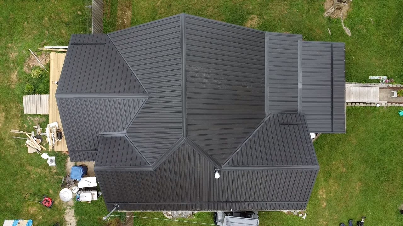 Top-down view of a large charcoal metal roof
